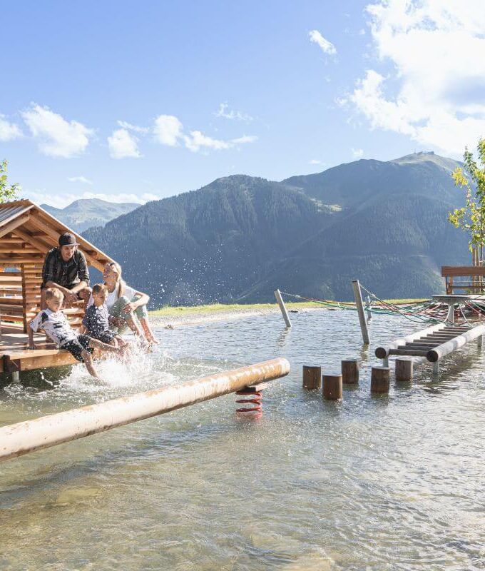 A young family cools off at the water playground.