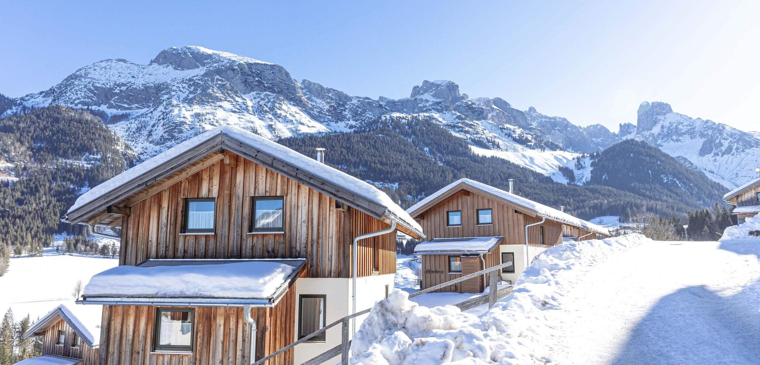 Gemütliche Ferienhäuser im Schnee mit Blick auf die Bischofsmütze