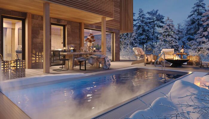 Ferienhaus mit Pool und Feuerschale in romantischer Winternacht