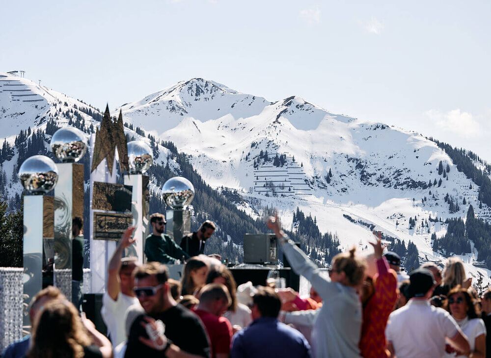 DJs and partying crowds against a wintry mountain backdrop at the White Pearl Mountain Days