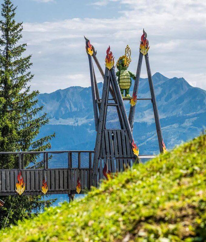 A giant climbing structure for children featuring Schmidolin, the fire breathing dragon mascot of the Schmittenhöhe.