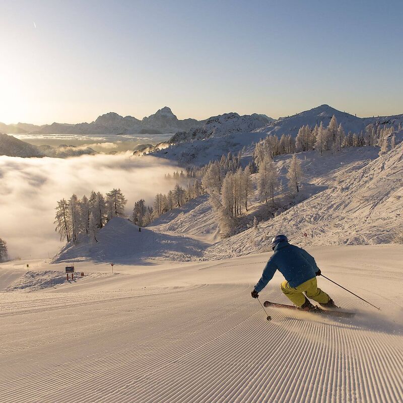 Skiers at Nassfeld above the clouds