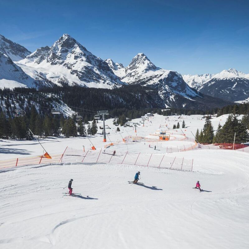 Parents with child skiing in a funslope