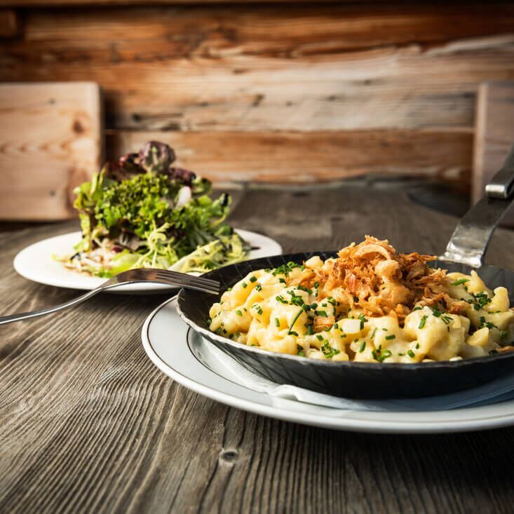 Cheese spaetzle with brown butter and onions in a cast-iron pan